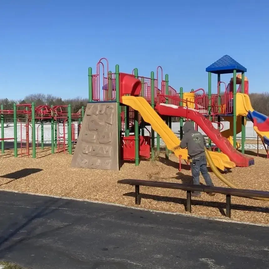 Colorful playground with slides and climbing walls under a clear sky.