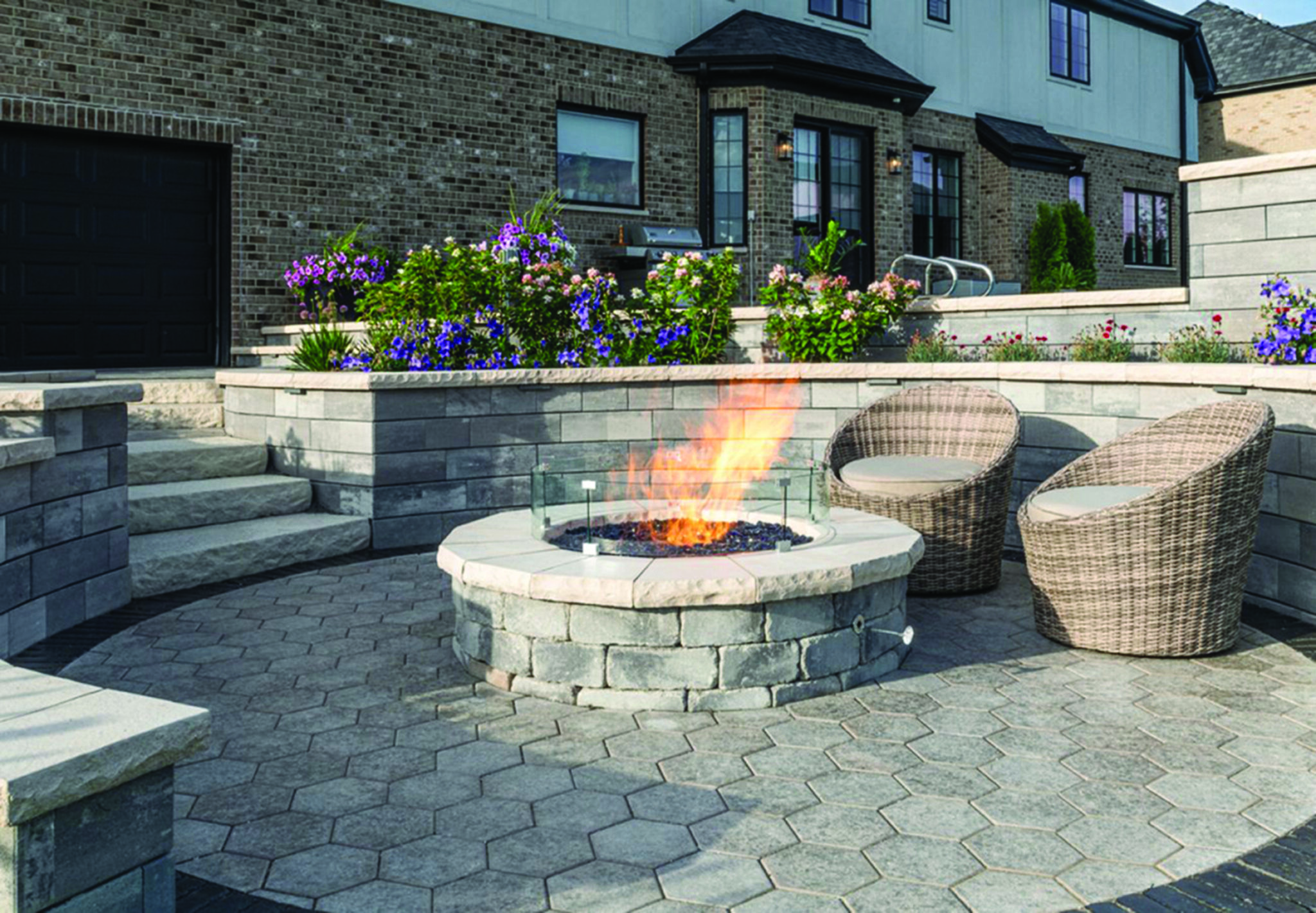 Patio with stone fire pit and wicker chairs