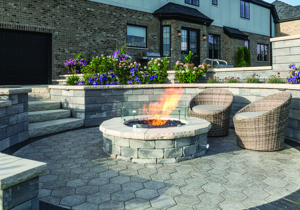 Patio with stone fire pit and wicker chairs