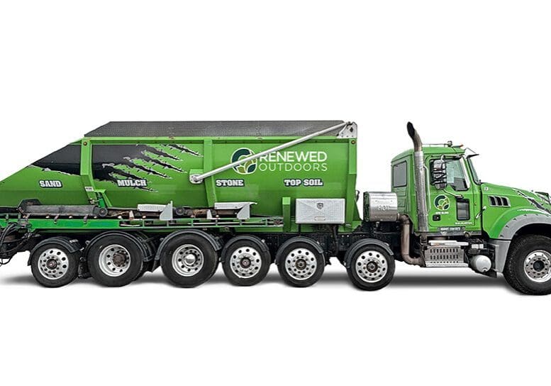 Green multi-axle landscaping dump truck